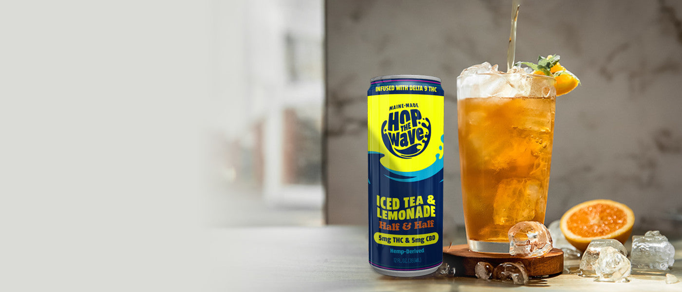 A can of Hop the Wave Iced Tea & Lemonade next to an ice-filled glass with iced tea getting poured into it.